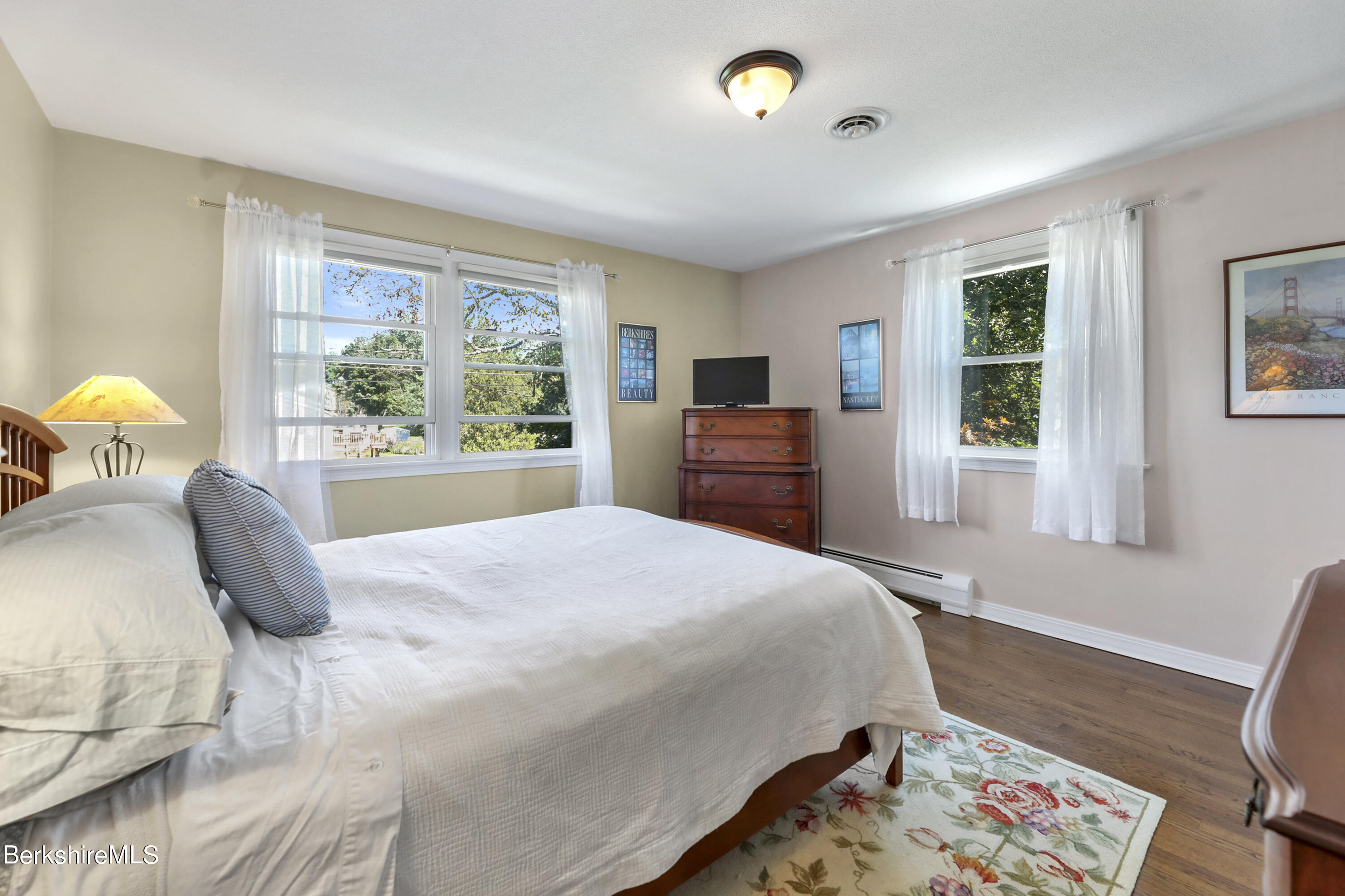 84 Brookside Drive Pittsfield, MA 01201 - Photo 28 of 54 a bedroom with a bed and wooden floor