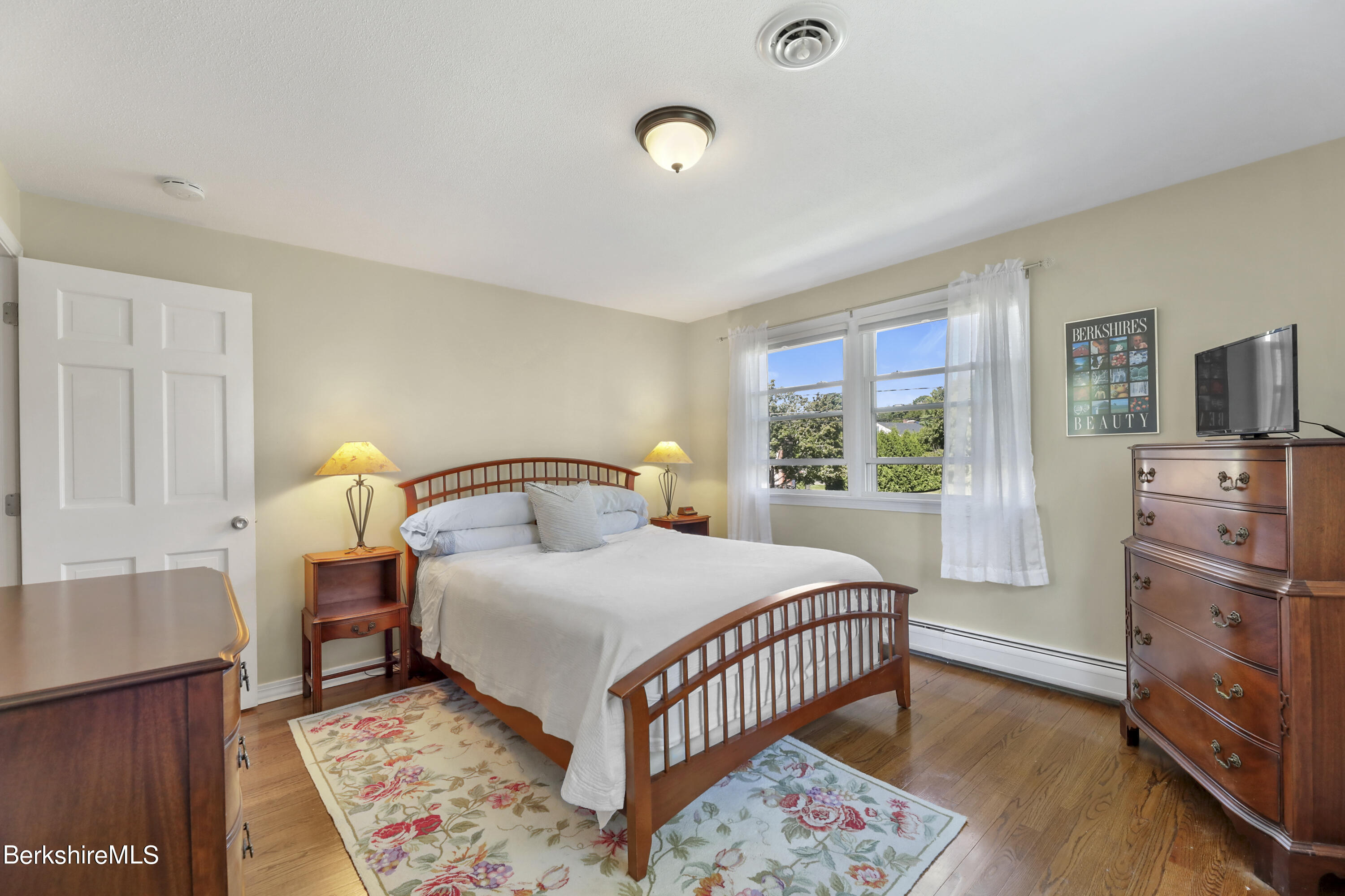 84 Brookside Drive Pittsfield, MA 01201 - Photo 29 of 54 a bedroom with a bed and wooden floor