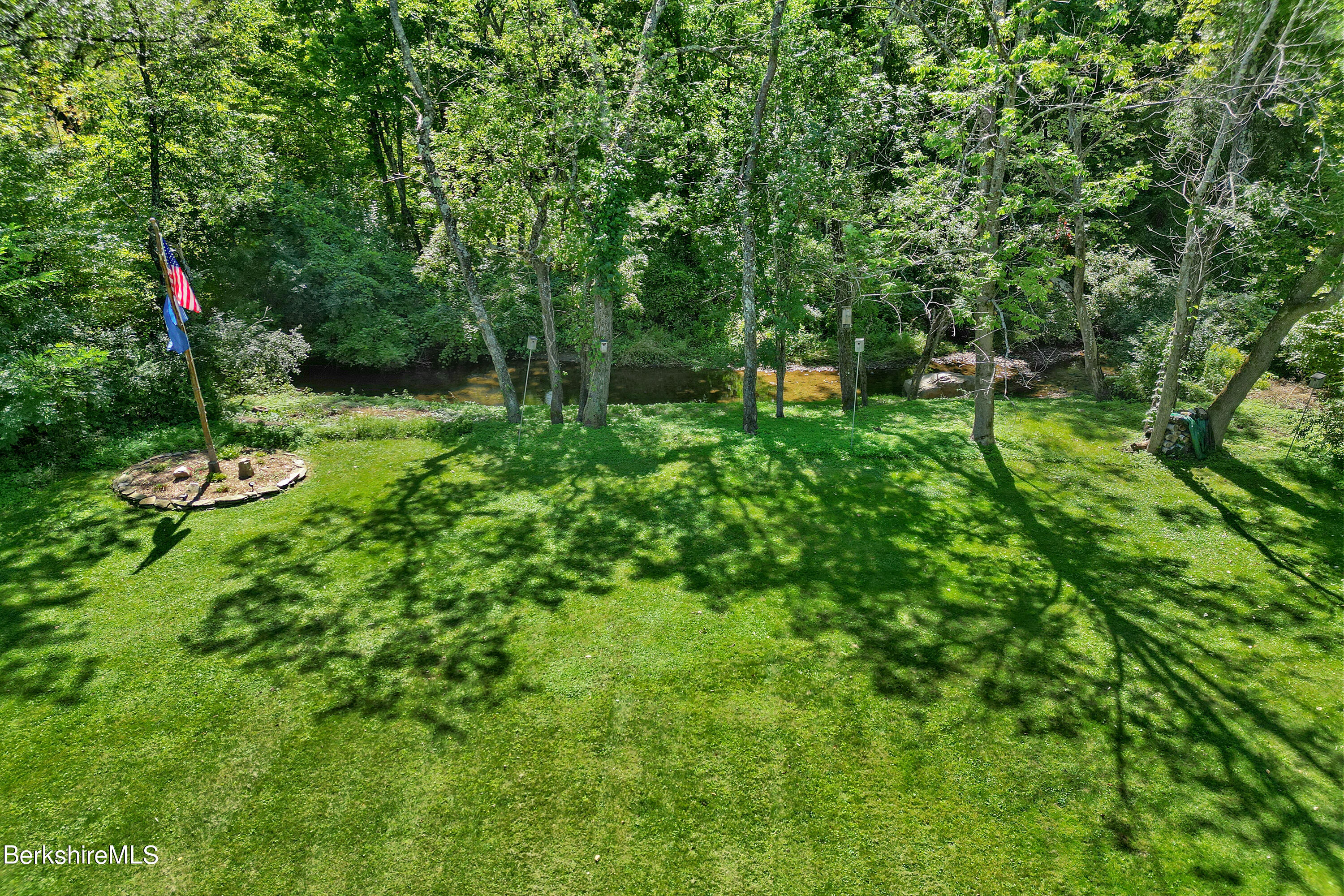 84 Brookside Drive Pittsfield, MA 01201 - Photo 54 of 54 a view of a green field with lots of bushes