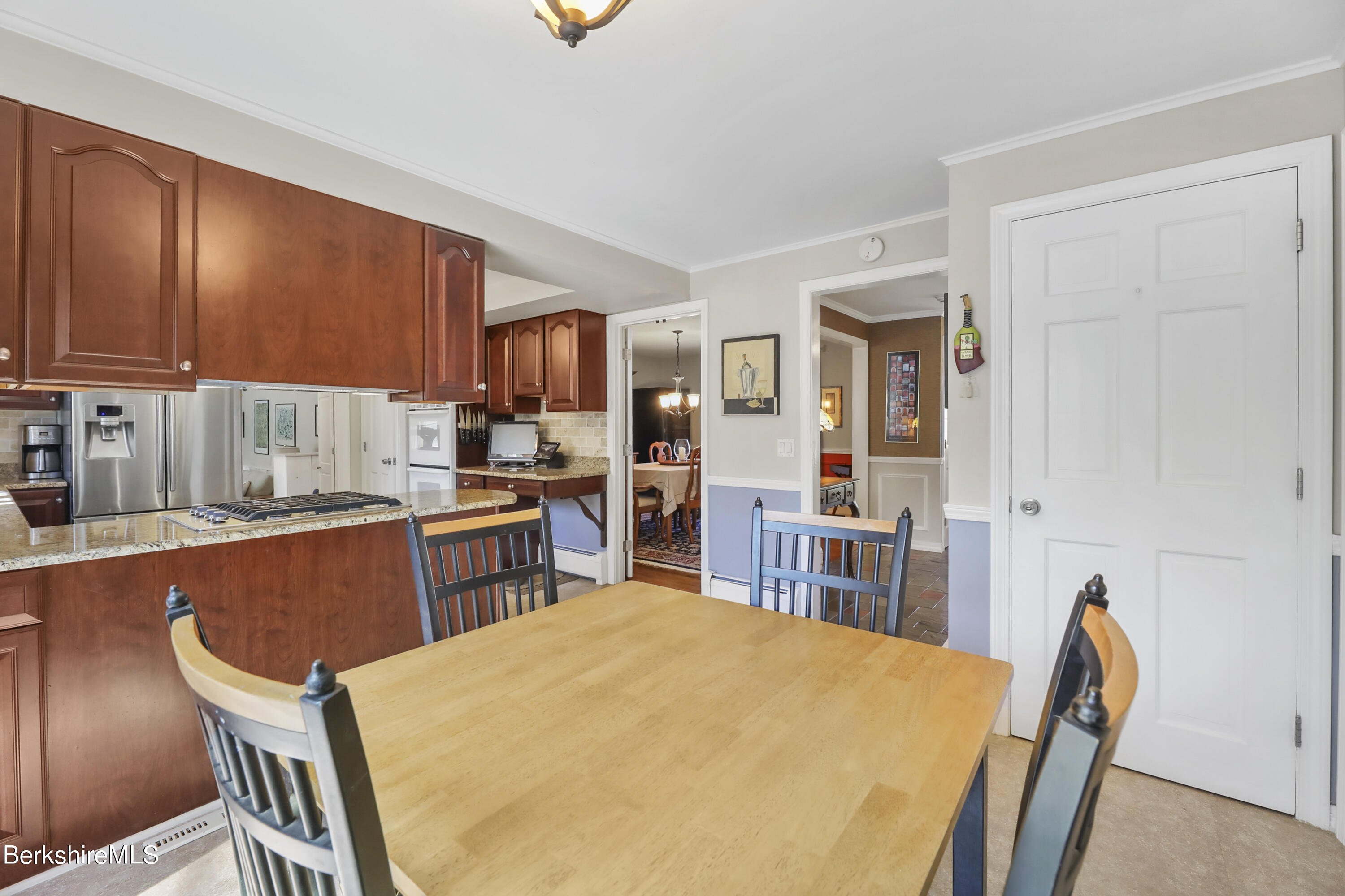 84 Brookside Drive Pittsfield, MA 01201 - Photo 9 of 54 a kitchen with stainless steel appliances wooden floors and wooden cabinets