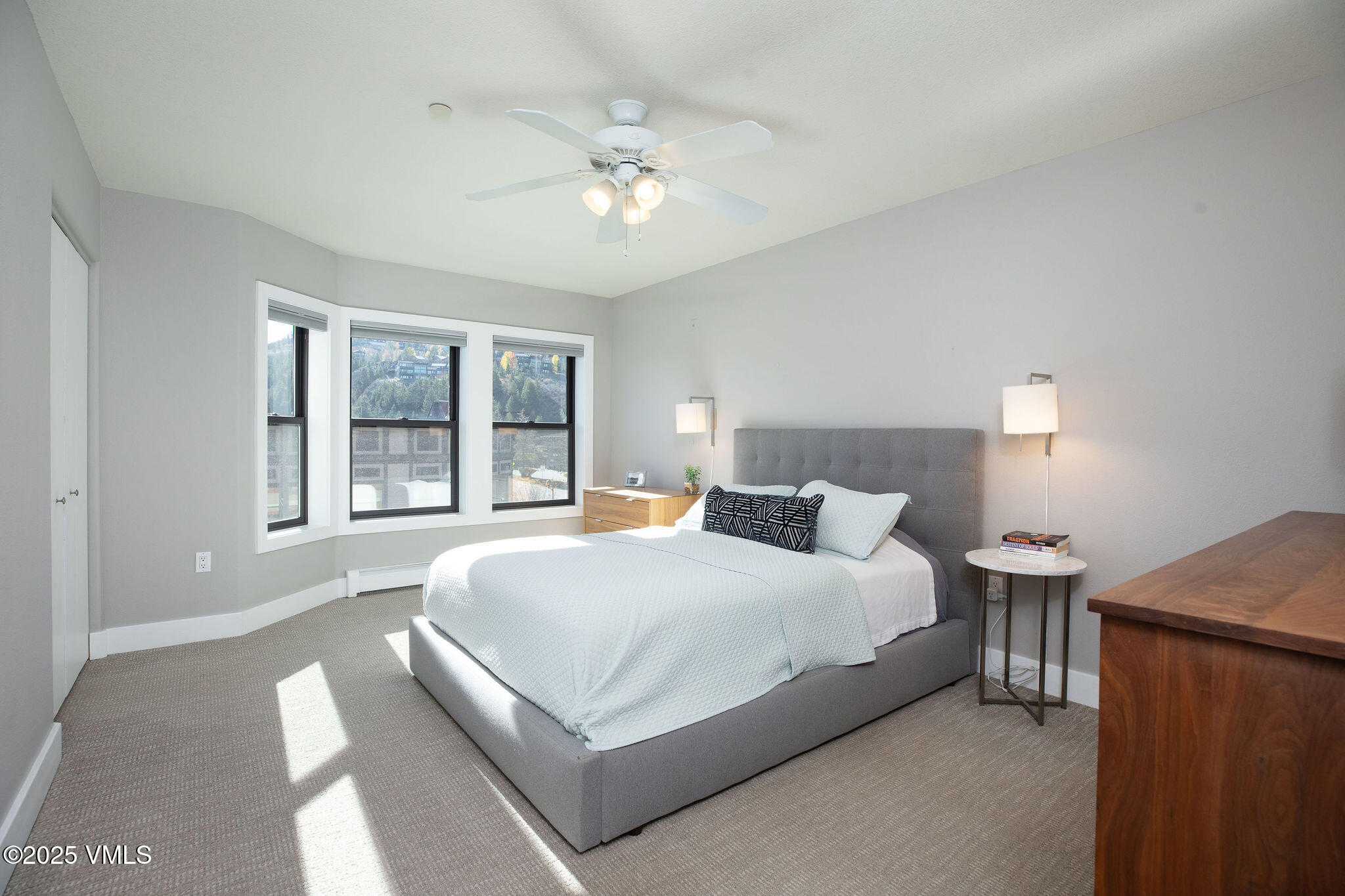 216 Main Street, Unit R311 Edwards, CO 81632 - Photo 6 of 9 a bedroom with a large bed and a chandelier