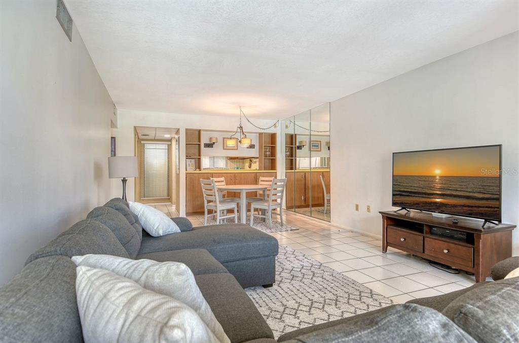 6157 Midnight Pass Road, Unit E63 Sarasota, FL 34242 - Photo 16 of 61 a living room with furniture and a flat screen tv