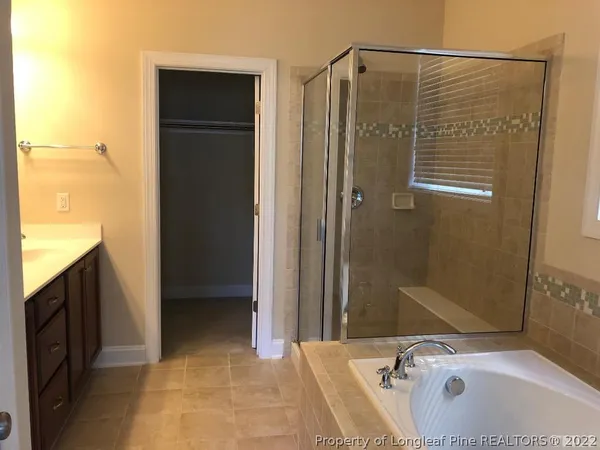 a bathroom with a tub and a sink