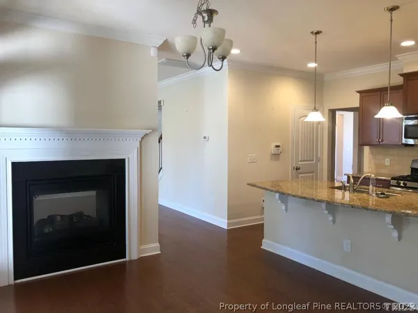 a kitchen with a sink and chandelier