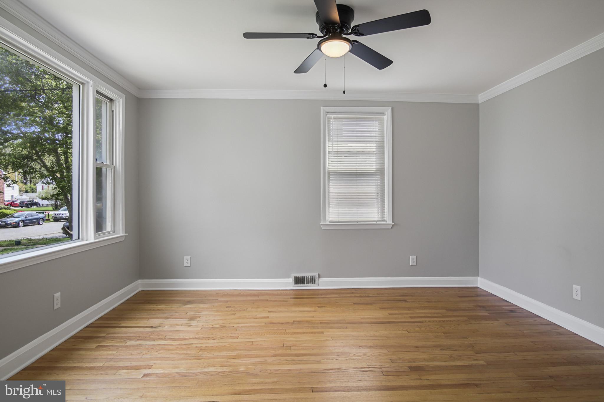 608 Farmhurst Road Baltimore, MD 21208 - Photo 10 of 45 wooden floor in an empty room with a window
