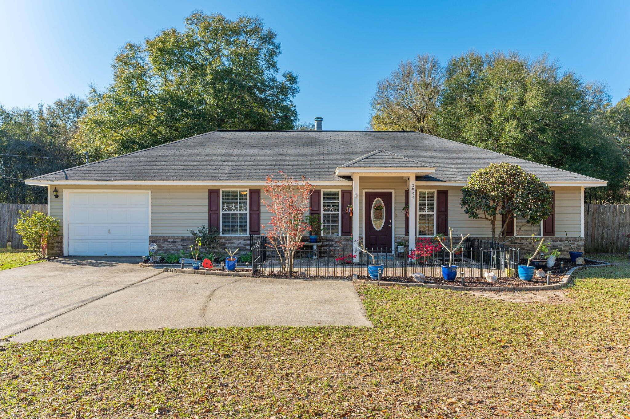 8933 Highway 90 Milton, FL 32583 - Photo 1 of 31 a front view of a house with sitting area and garden