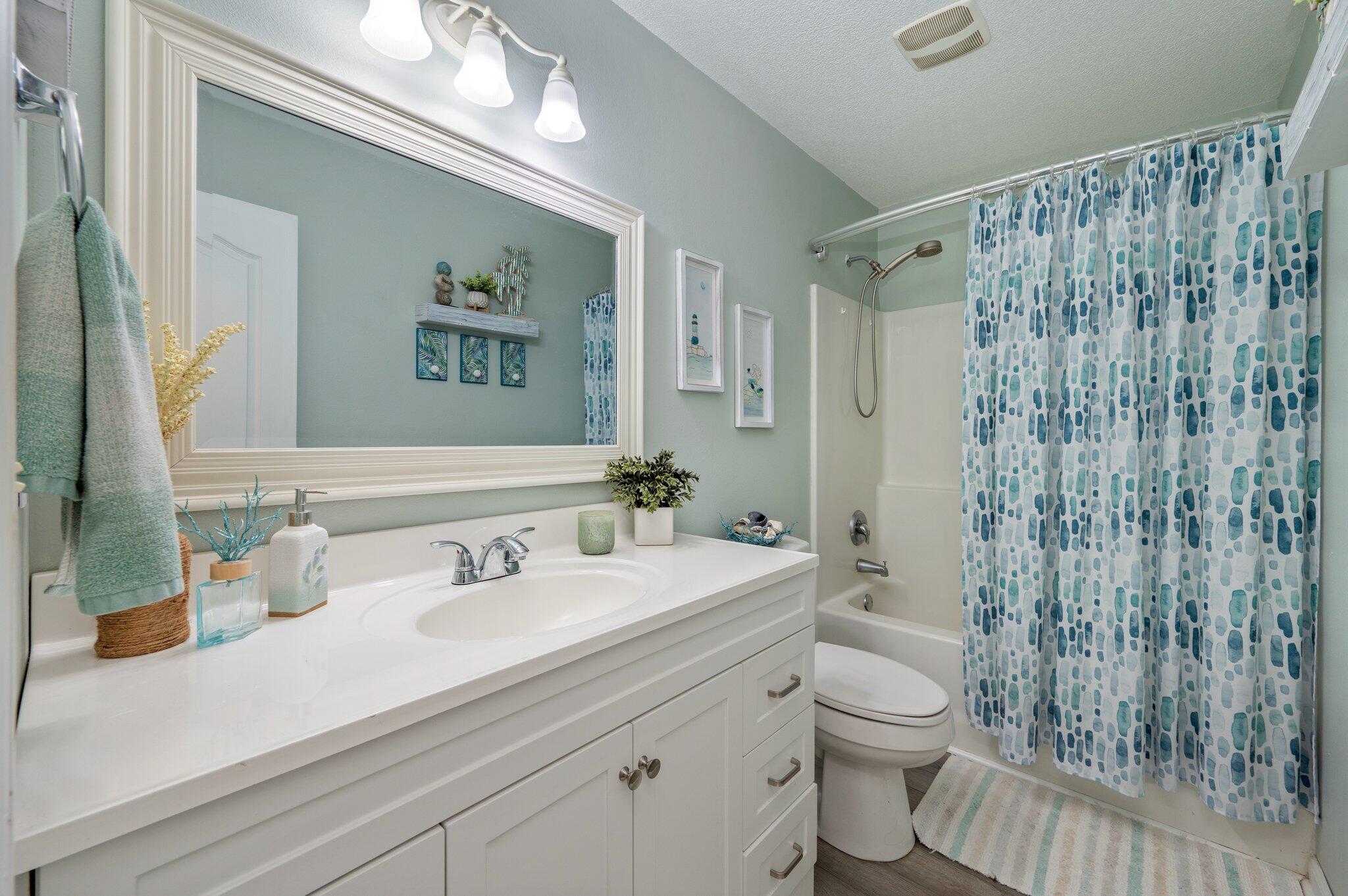 8933 Highway 90 Milton, FL 32583 - Photo 13 of 31 a bathroom with a sink a toilet and shower