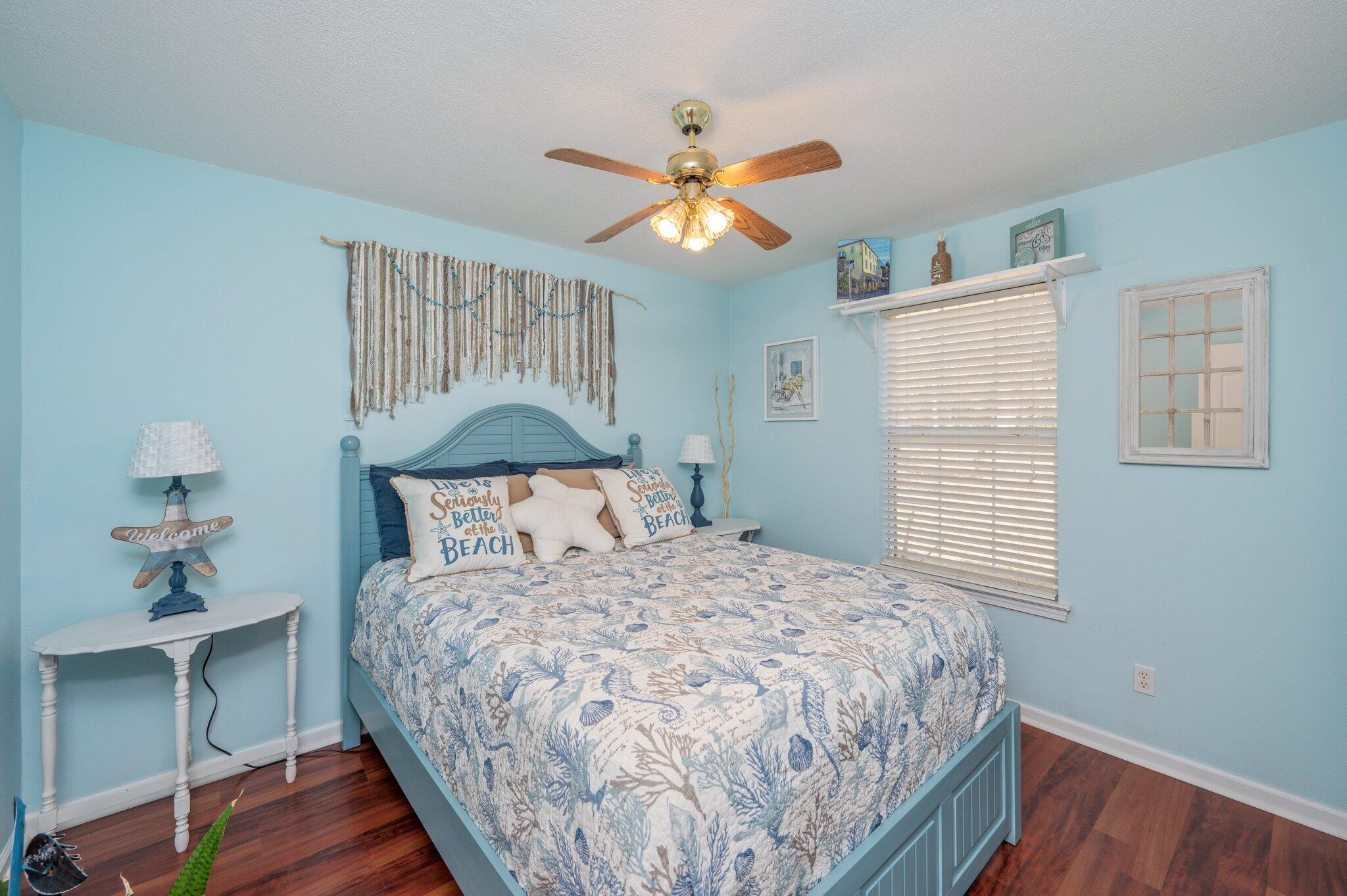 8933 Highway 90 Milton, FL 32583 - Photo 17 of 31 a bedroom with a bed and a chandelier