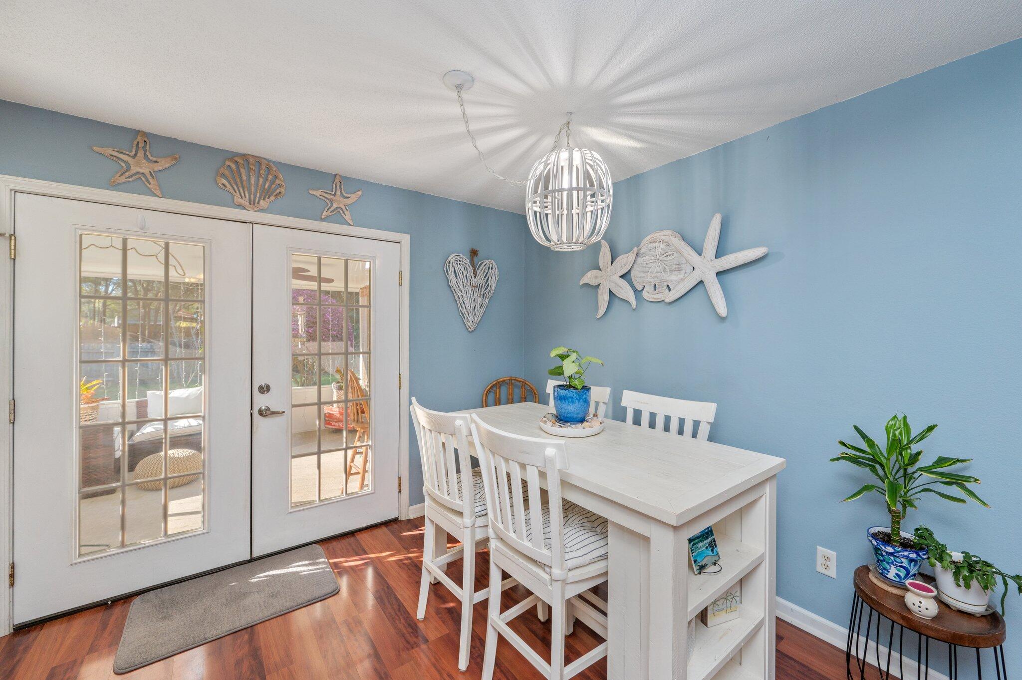 8933 Highway 90 Milton, FL 32583 - Photo 18 of 31 a view of a dining room with furniture a chandelier and wooden floor