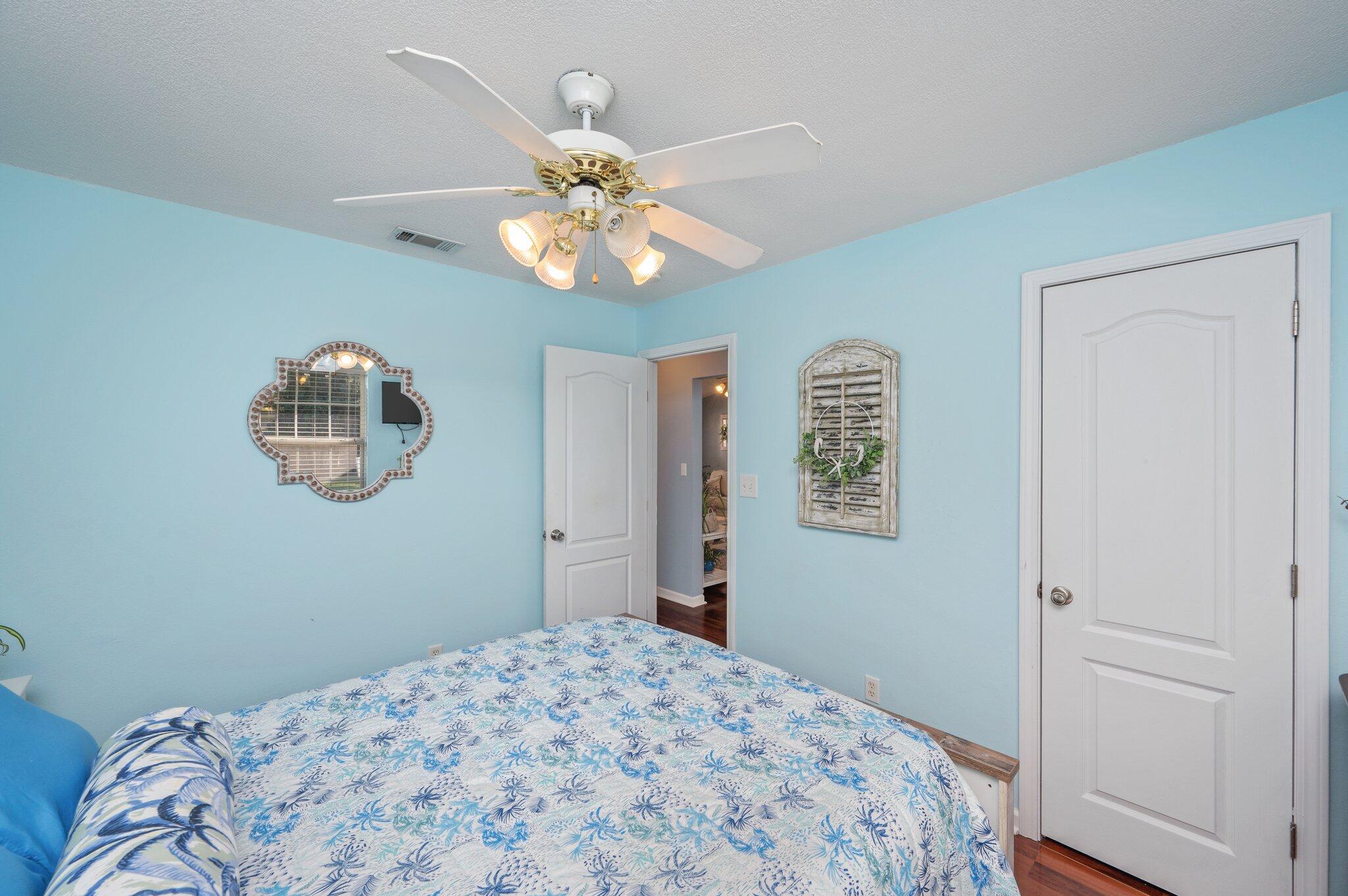 8933 Highway 90 Milton, FL 32583 - Photo 20 of 31 a bedroom with a large bed and a chandelier