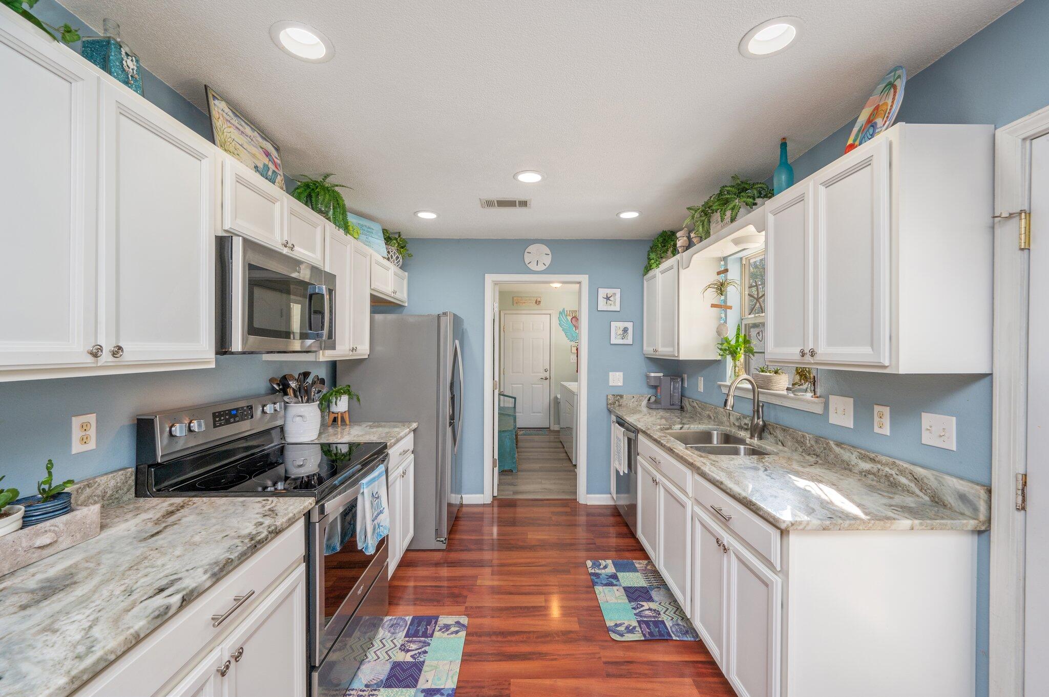 8933 Highway 90 Milton, FL 32583 - Photo 2 of 31 a kitchen with stainless steel appliances granite countertop a stove a sink and a refrigerator