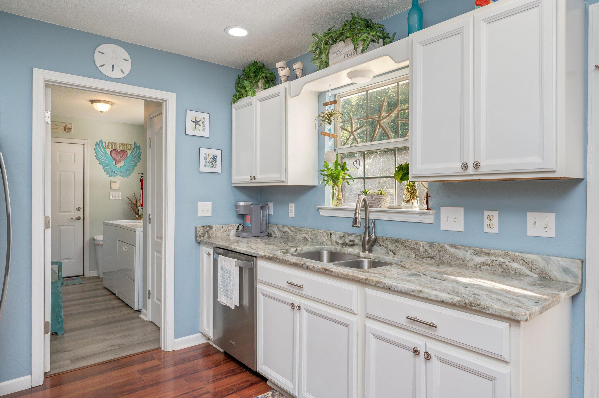 8933 Highway 90 Milton, FL 32583 - Photo 25 of 31 a kitchen with sink cabinets and window