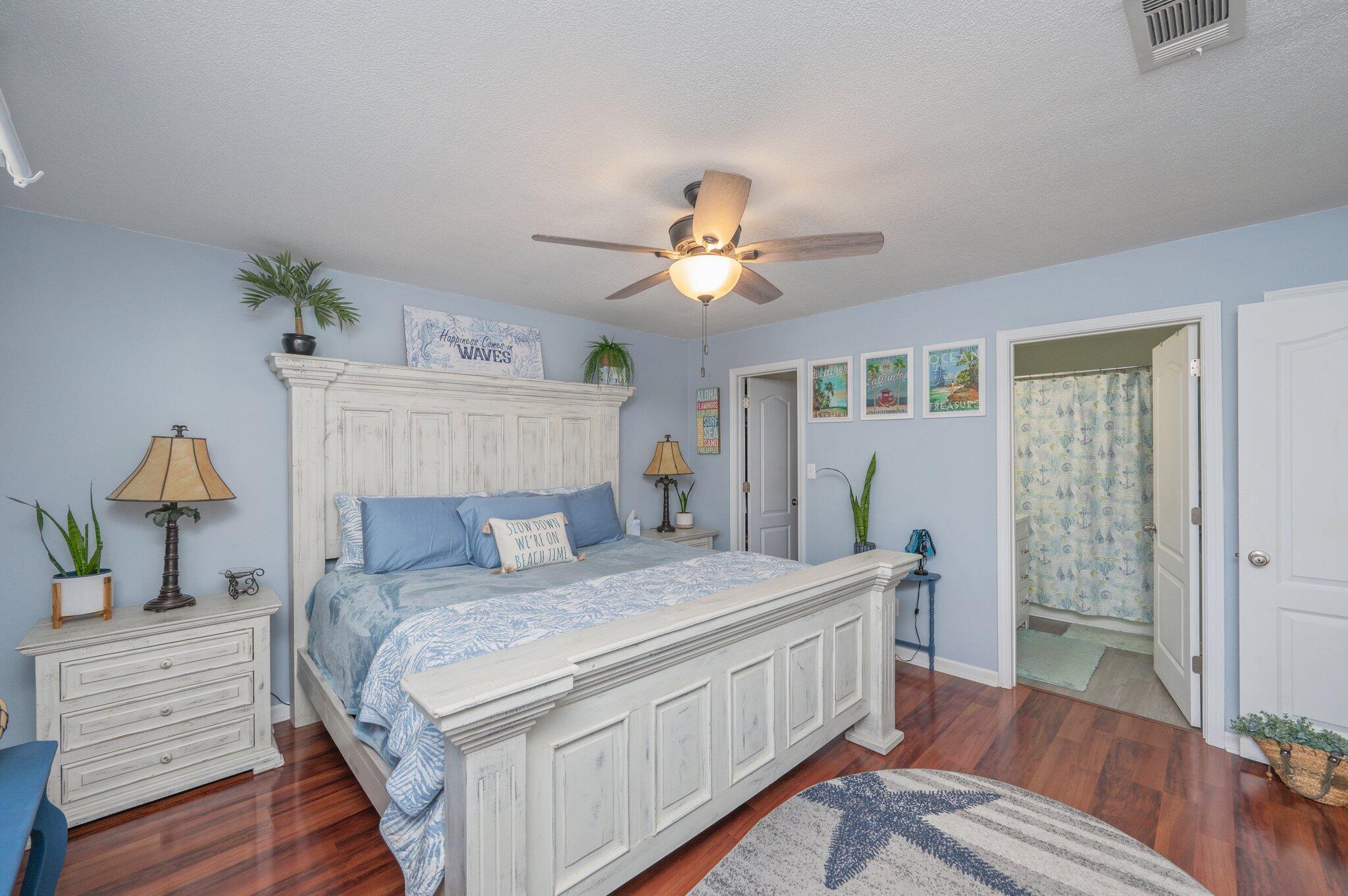 8933 Highway 90 Milton, FL 32583 - Photo 26 of 31 a bedroom with a bed and a chandelier
