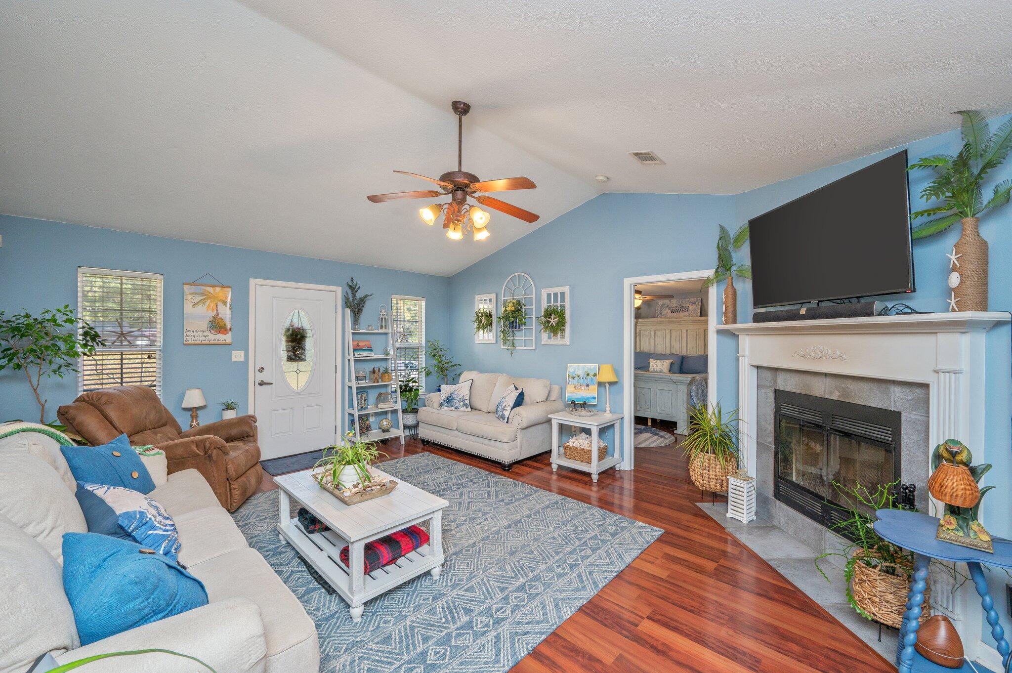8933 Highway 90 Milton, FL 32583 - Photo 4 of 31 a living room with furniture a flat screen tv and a fireplace