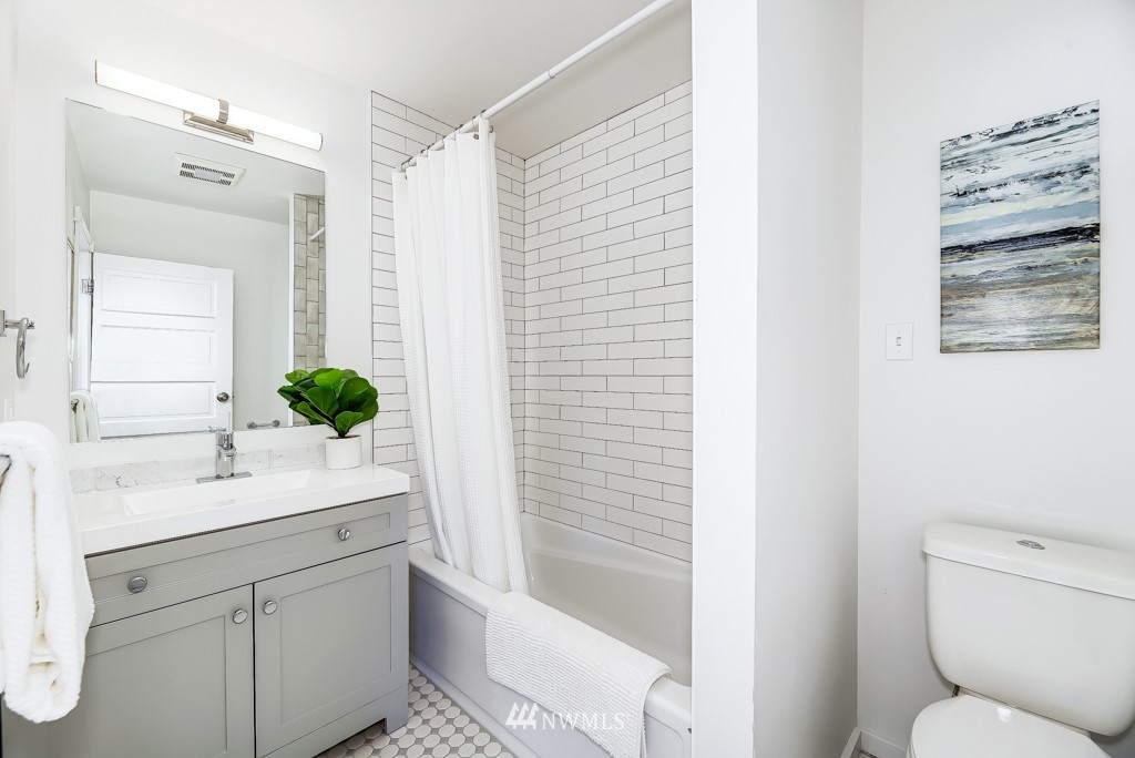 2117 Southwest Trenton Street Seattle, WA 98106 - Photo 13 of 18 a bathroom with a sink a toilet and shower