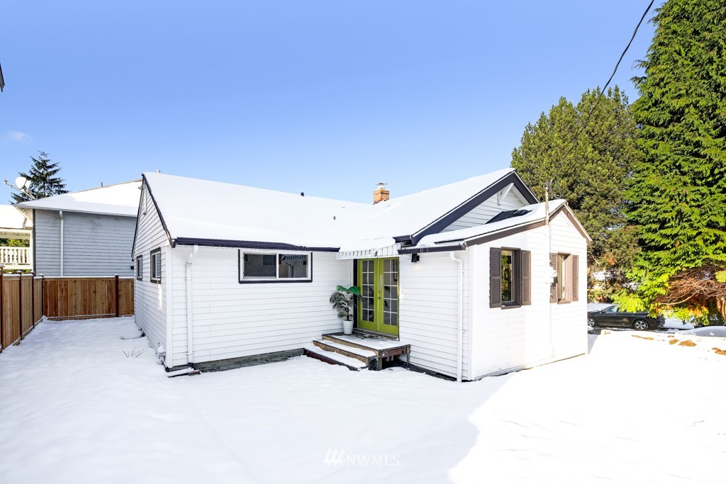 2117 Southwest Trenton Street Seattle, WA 98106 - Photo 18 of 18 a view of a white house with a yard and garage