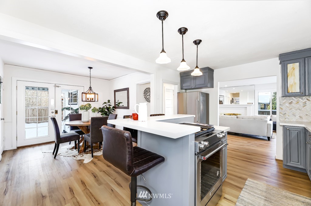 2117 Southwest Trenton Street Seattle, WA 98106 - Photo 8 of 18 a living room with furniture kitchen view and a wooden floor