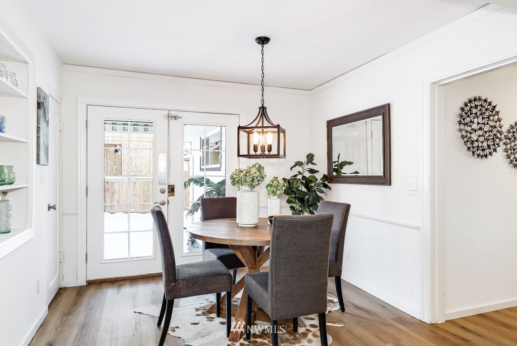 2117 Southwest Trenton Street Seattle, WA 98106 - Photo 9 of 18 a view of a dining room with furniture window and wooden floor