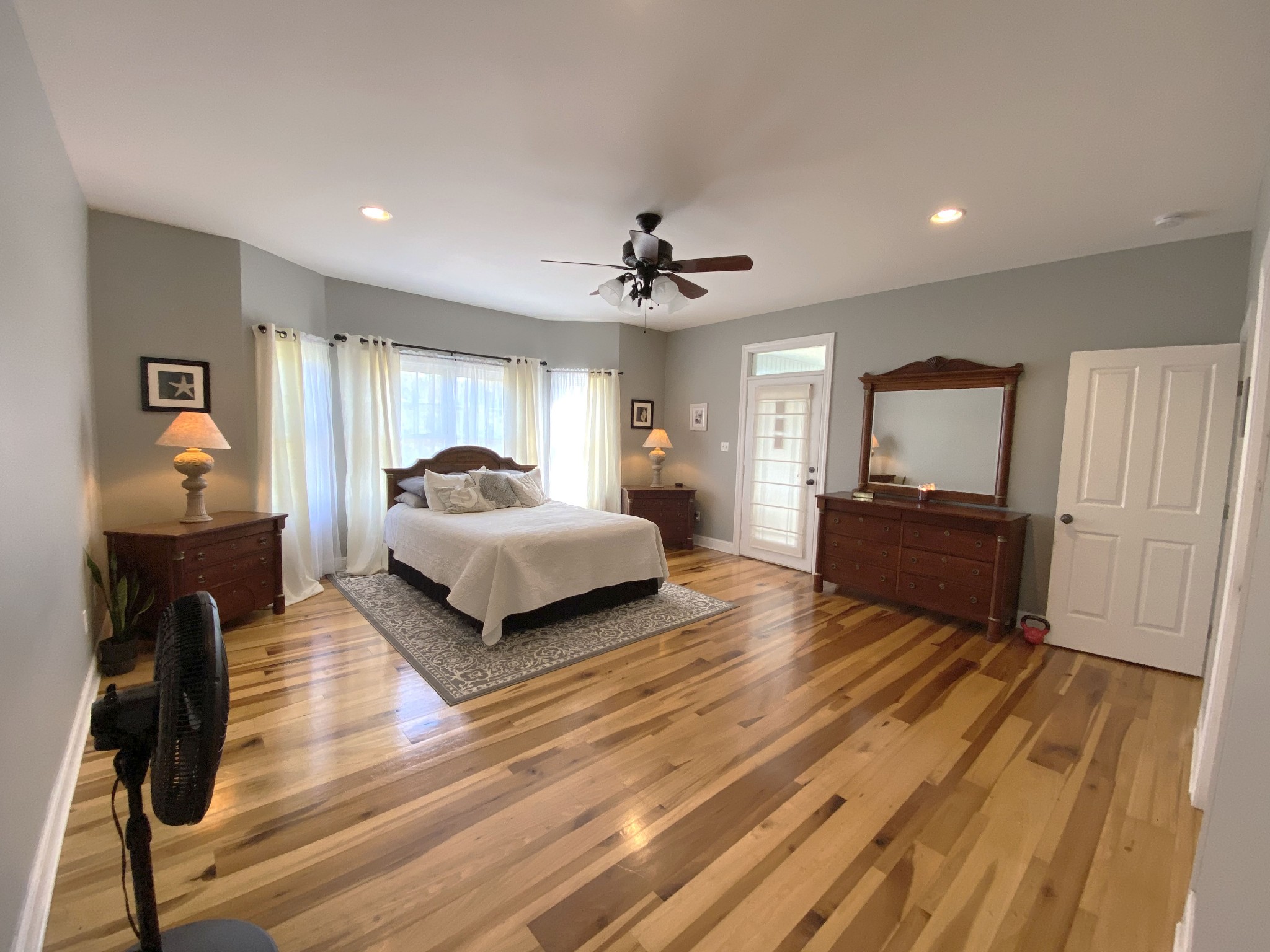 585 Blooming Grove Road Pulaski, TN 38478 - Photo 9 of 41 a spacious bedroom with a bed and a chandelier