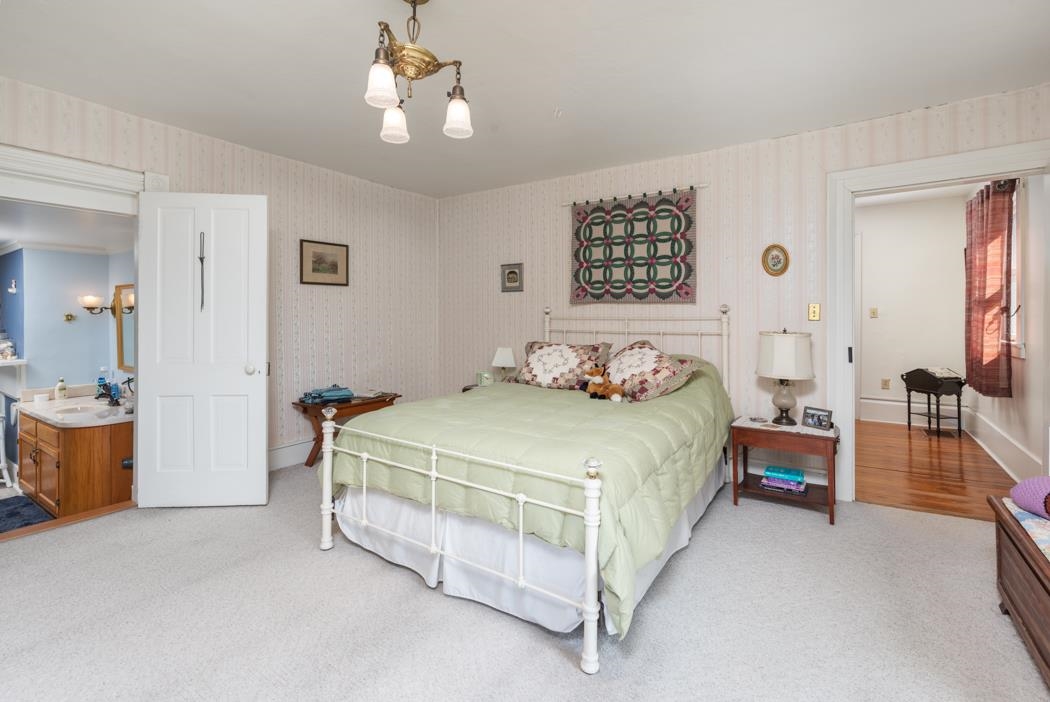 3643 Middlebrook Road Middlebrook, VA 24459 - Photo 20 of 35 a spacious bedroom with a bed and a chandelier