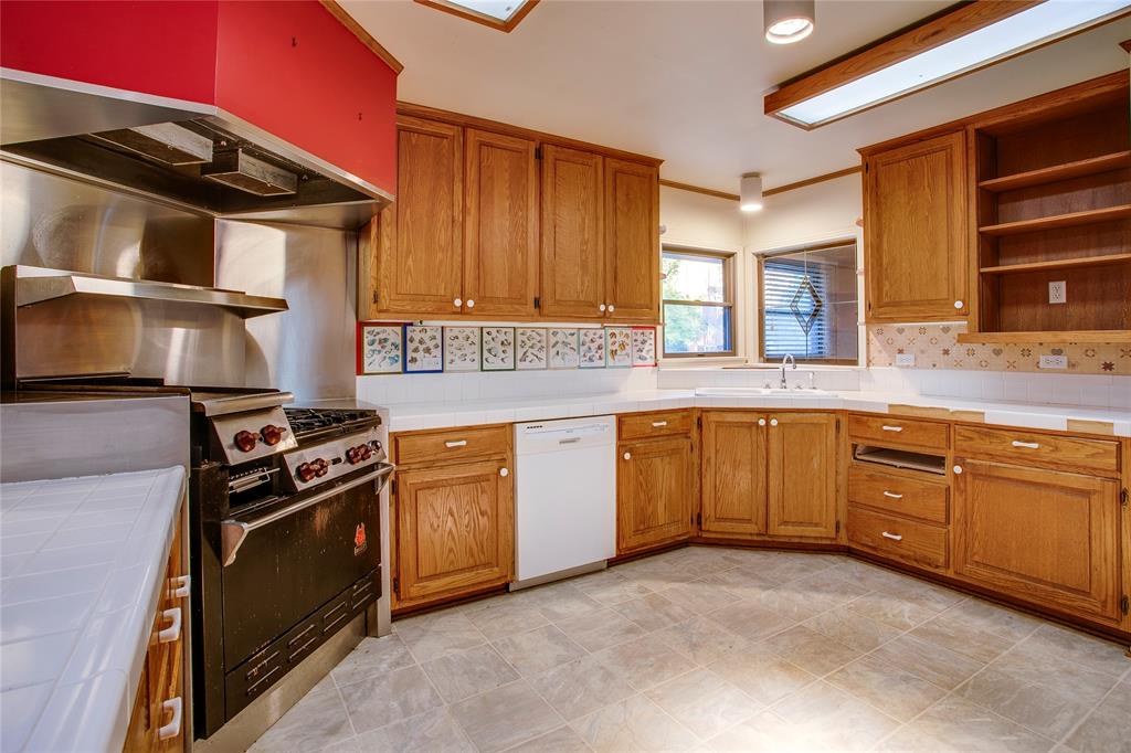 1439 Jr Drive Dallas, TX 75208 - Photo 8 of 39 a kitchen with stainless steel appliances granite countertop a stove a sink and a microwave