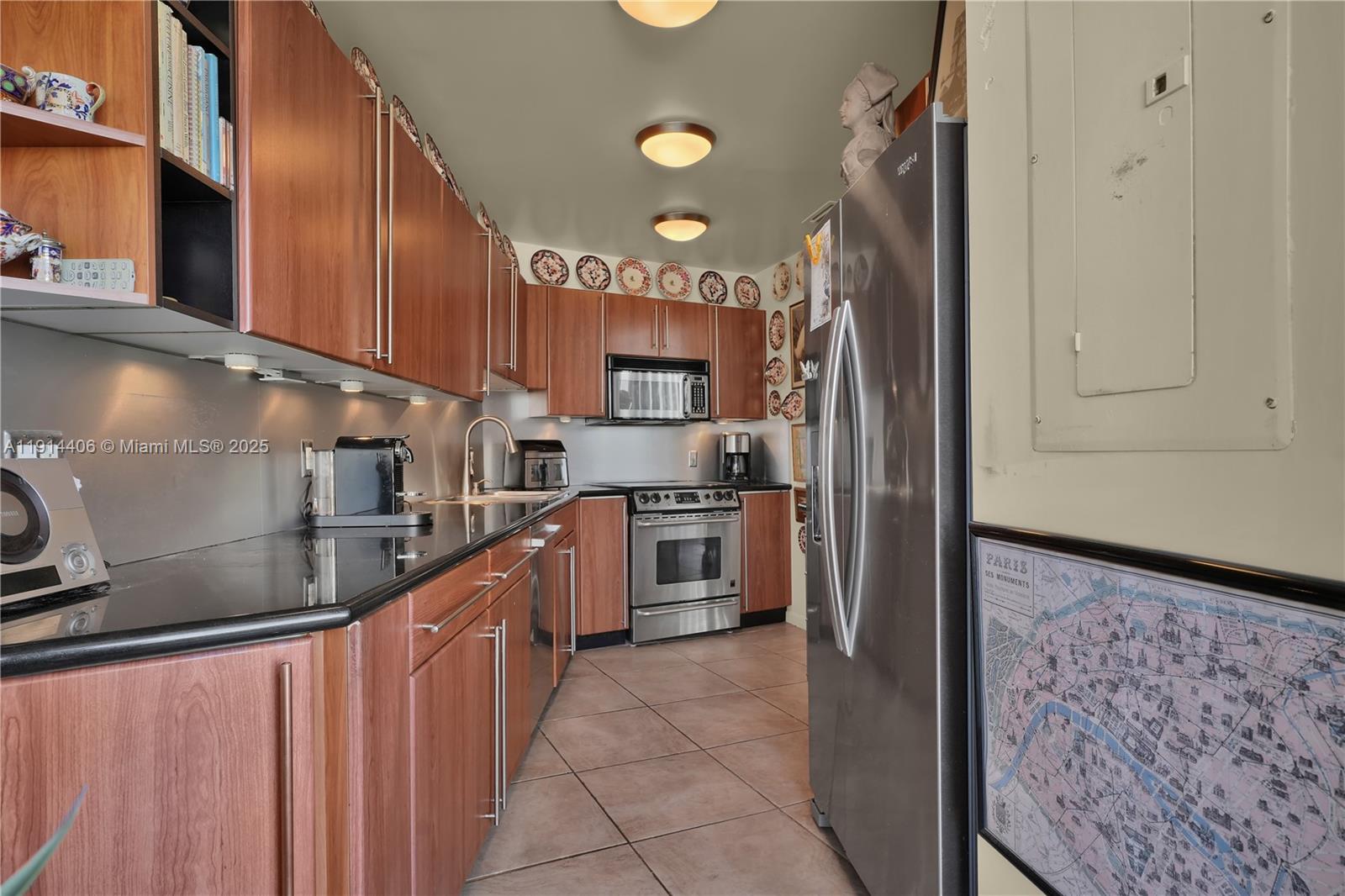 720 Northeast 69th Street, Unit 9W Miami, FL 33138 - Photo 12 of 27 a kitchen with stainless steel appliances granite countertop a stove a sink and a refrigerator