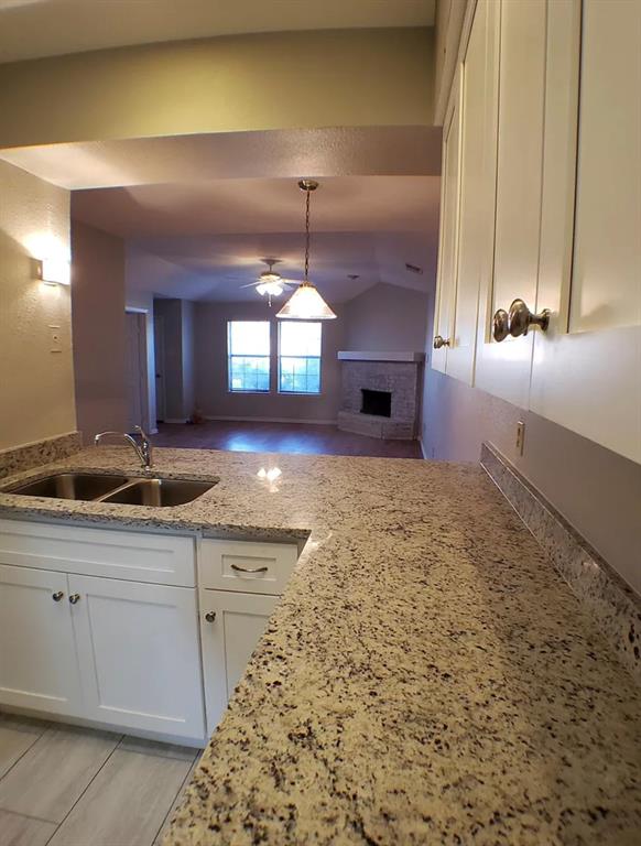 9693 Windy Ridge Road Frisco, TX 75033 - Photo 26 of 26 a view of a kitchen with a sink and chandelier