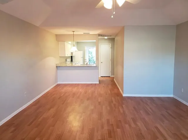 a view of a kitchen with a sink and chandelier