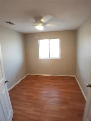 a view of a kitchen with wooden floor and a sink
