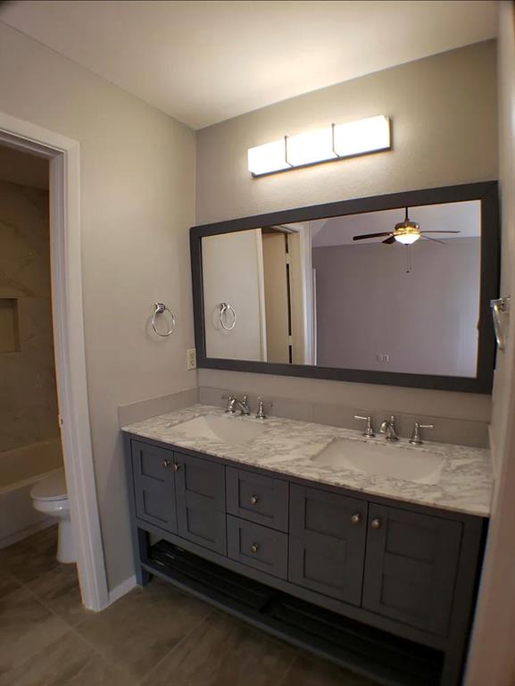 9693 Windy Ridge Road Frisco, TX 75033 - Photo 13 of 26 a bathroom with a double vanity sink and a mirror