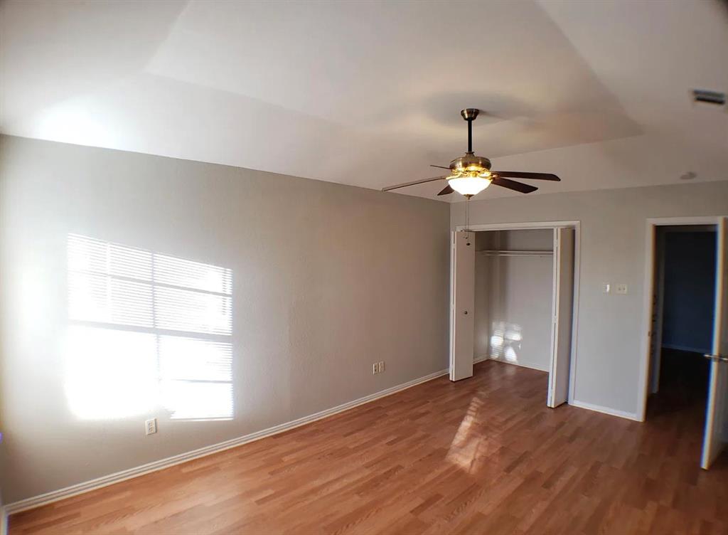 9693 Windy Ridge Road Frisco, TX 75033 - Photo 15 of 26 a view of empty room with wooden floor and fan