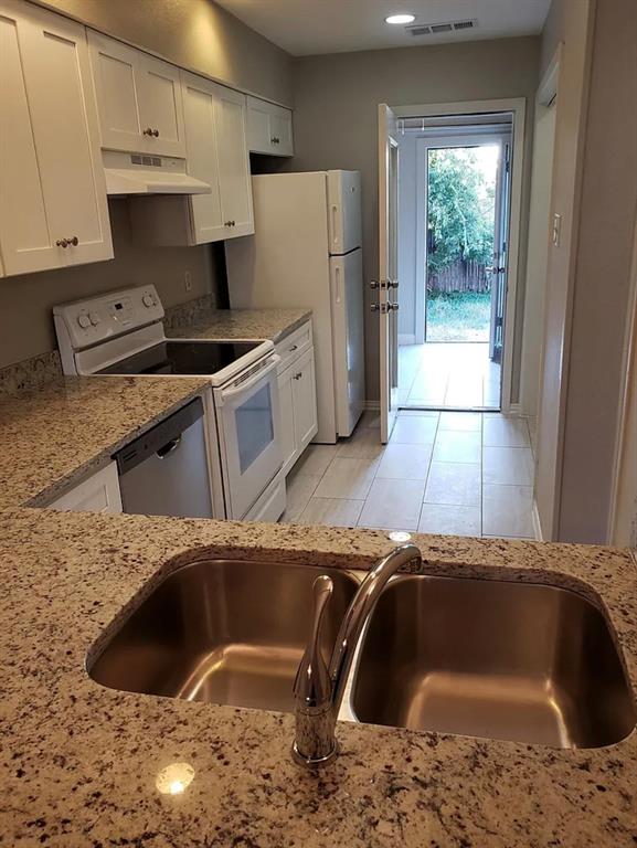 9693 Windy Ridge Road Frisco, TX 75033 - Photo 17 of 26 a kitchen with a sink a stove and refrigerator