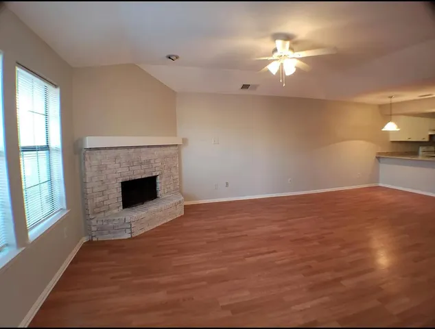 a view of empty room with a fireplace