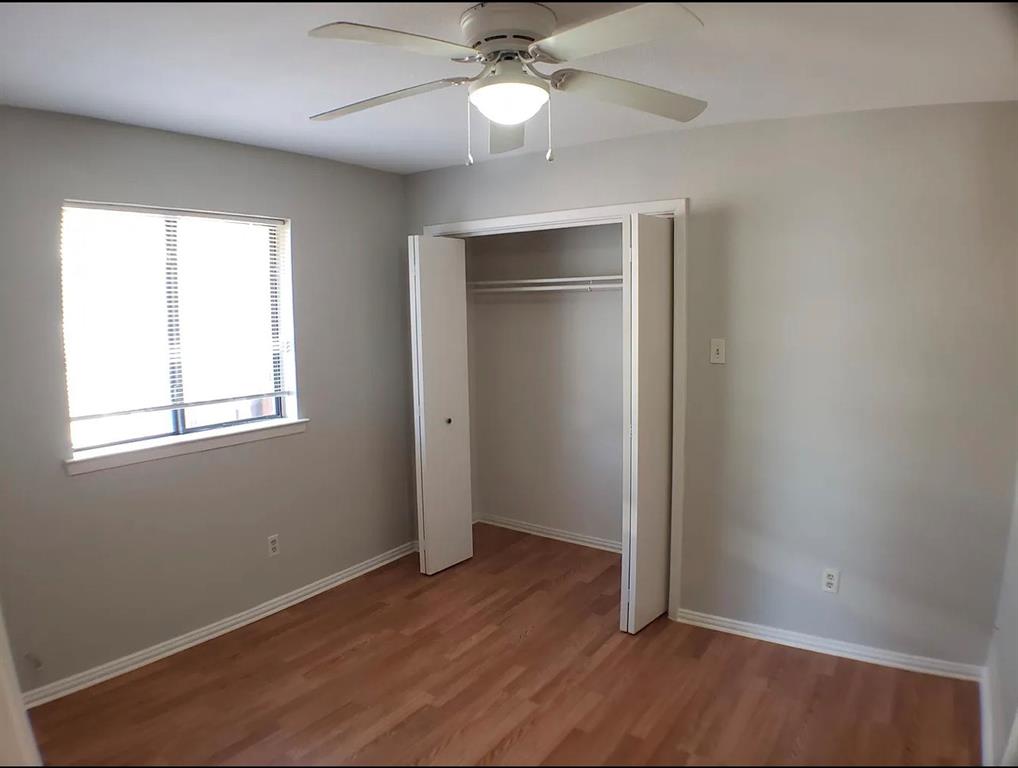 9693 Windy Ridge Road Frisco, TX 75033 - Photo 21 of 26 an empty room with wooden floor closet and windows