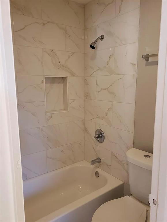 9693 Windy Ridge Road Frisco, TX 75033 - Photo 22 of 26 a bathroom with a toilet and a bathtub