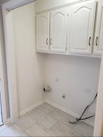 a view of a hallway with wooden floor and closet area