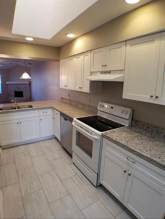 9693 Windy Ridge Road Frisco, TX 75033 - Photo 9 of 26 a kitchen with granite countertop a sink a stove and cabinets