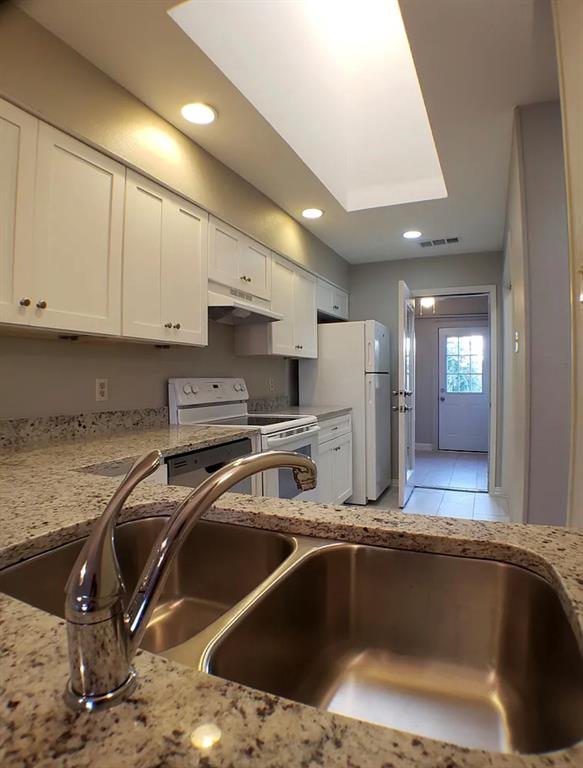 9693 Windy Ridge Road Frisco, TX 75033 - Photo 10 of 26 a kitchen with stainless steel appliances granite countertop a sink a stove and a refrigerator