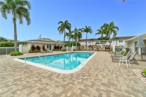 a view of a swimming pool with a lounge chair