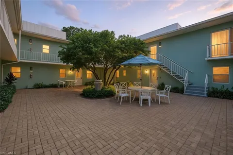 a view of a house with backyard and a patio