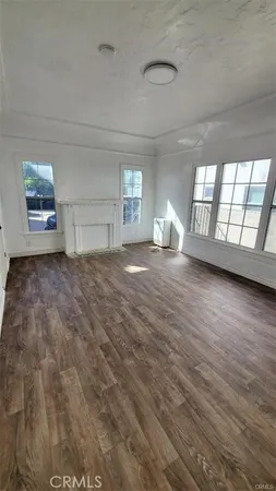 a view of a livingroom with wooden floor and window