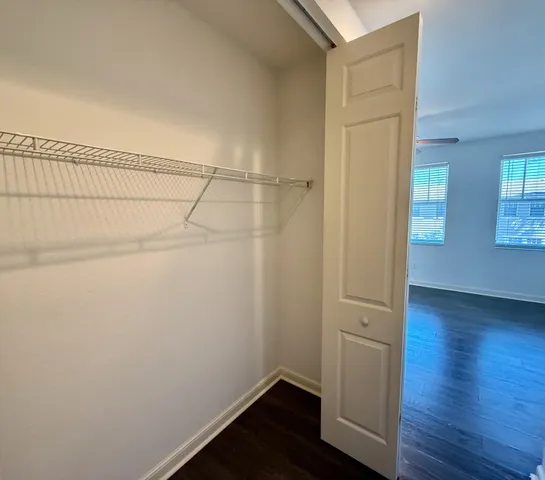 a view of small space with wooden floor and cabinet