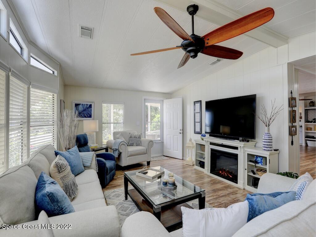 727 Periwinkle Drive Sebastian, FL 32976 - Photo 11 of 34 a living room with furniture a flat screen tv and a window