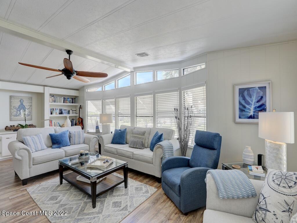 727 Periwinkle Drive Sebastian, FL 32976 - Photo 12 of 34 a living room with furniture a rug potted plant and a large window