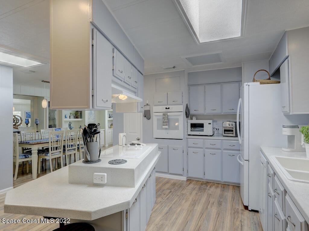 727 Periwinkle Drive Sebastian, FL 32976 - Photo 14 of 34 a kitchen with kitchen island a sink counter top space and stainless steel appliances