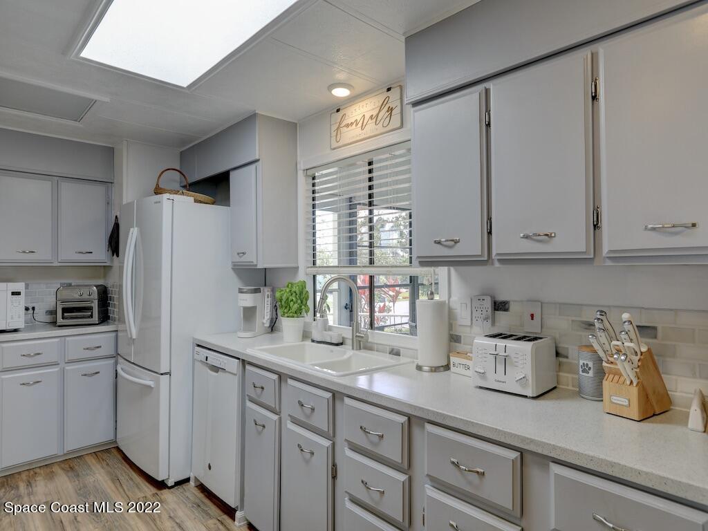 727 Periwinkle Drive Sebastian, FL 32976 - Photo 15 of 34 a kitchen with stainless steel appliances white cabinets and a window