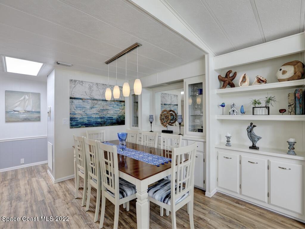 727 Periwinkle Drive Sebastian, FL 32976 - Photo 16 of 34 a view of a dining room with furniture and wooden floor