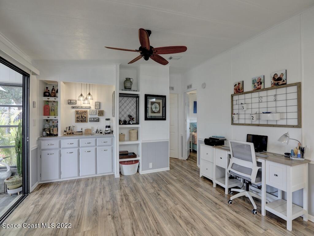 727 Periwinkle Drive Sebastian, FL 32976 - Photo 18 of 34 a kitchen with stainless steel appliances kitchen island hardwood floor stove sink and cabinets