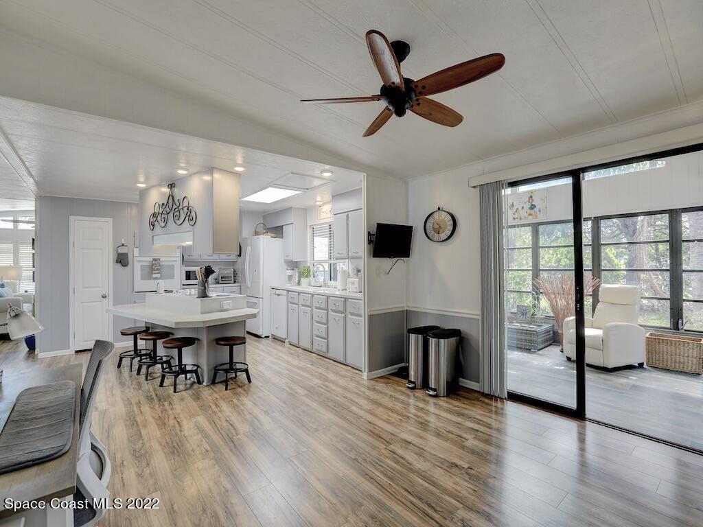727 Periwinkle Drive Sebastian, FL 32976 - Photo 19 of 34 a view of a dining room with furniture window and wooden floor