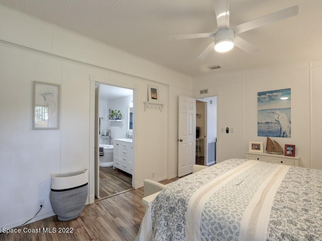 727 Periwinkle Drive Sebastian, FL 32976 - Photo 21 of 34 a bedroom with a bed and a view of bathroom